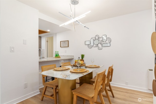 dining room featuring a chandelier and light hardwood / wood-style floors