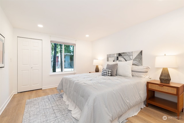 bedroom featuring light hardwood / wood-style floors and a closet