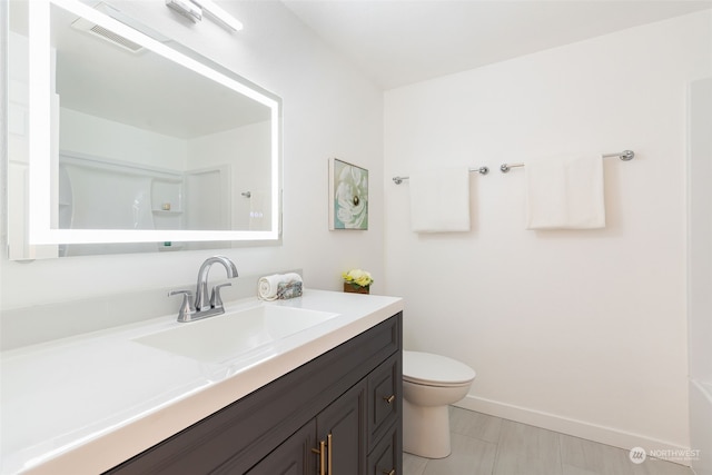 bathroom featuring toilet and vanity