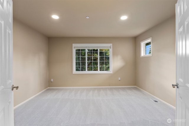 unfurnished room with light carpet