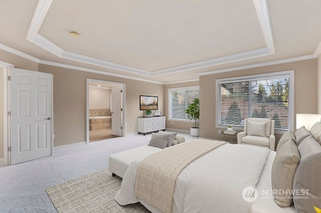 bedroom featuring ensuite bath, light colored carpet, multiple windows, and a raised ceiling