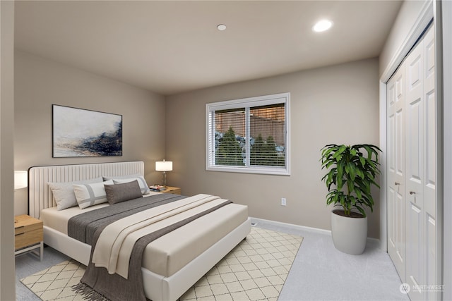 bedroom with light colored carpet and a closet