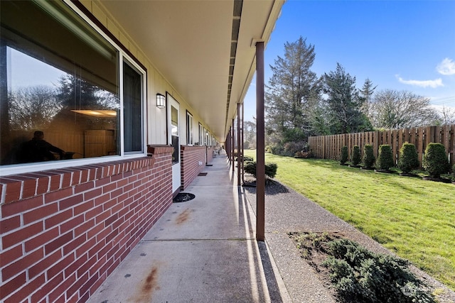 view of side of property with a yard and a patio area