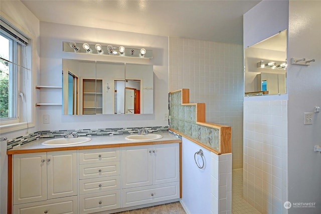 bathroom featuring walk in shower, vanity, and tasteful backsplash