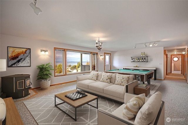 carpeted living room with track lighting, a wood stove, and billiards