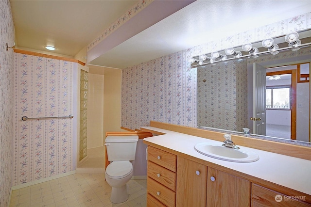 bathroom with toilet, walk in shower, and vanity