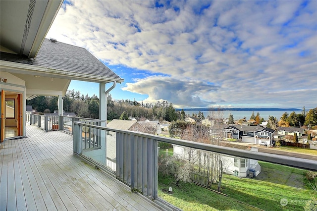 wooden terrace featuring a water view