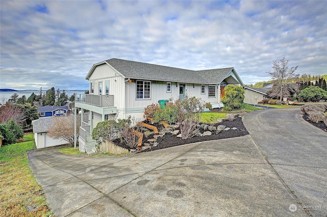 view of front of property with a balcony and a garage