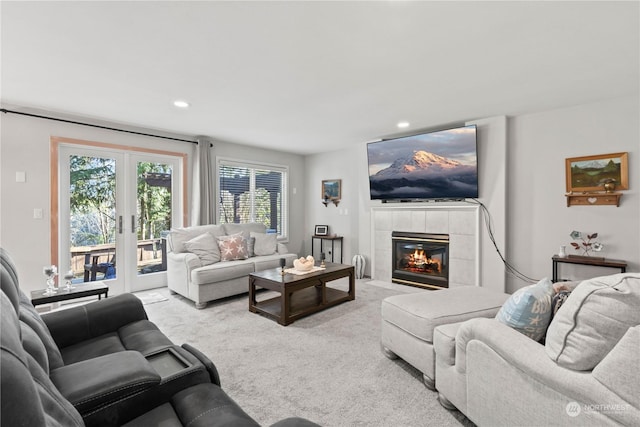 carpeted living room with french doors and a tile fireplace