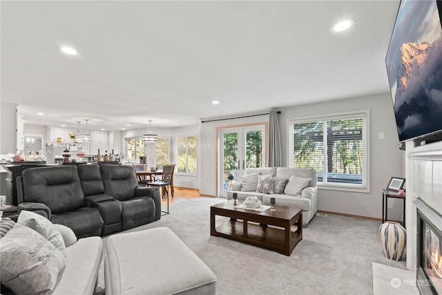 carpeted living room featuring french doors and a tile fireplace