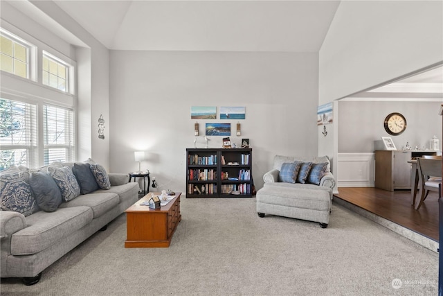 living room featuring vaulted ceiling and light colored carpet