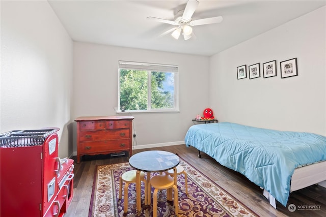 bedroom with ceiling fan and dark hardwood / wood-style flooring