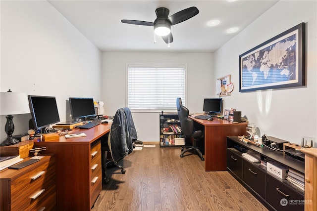 office with light hardwood / wood-style floors and ceiling fan