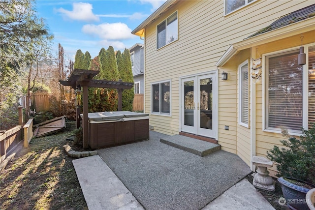 view of patio featuring french doors, a pergola, and a hot tub