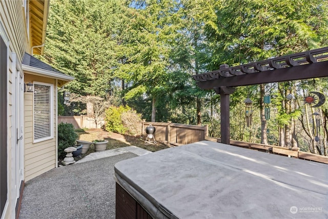 view of patio / terrace featuring a pergola and a hot tub