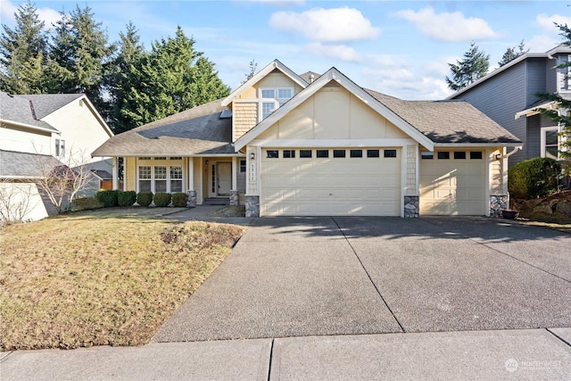 view of front of house featuring a garage and a front lawn