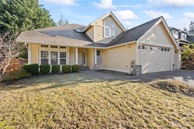 view of front of home with a front yard and a garage