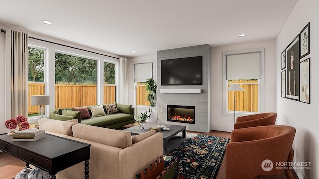 living room with hardwood / wood-style floors and a tile fireplace