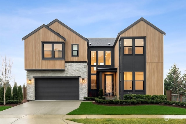 view of front of home with a front yard and a garage