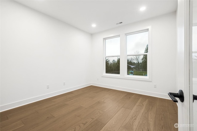 unfurnished room featuring hardwood / wood-style flooring