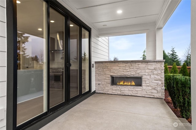 view of patio / terrace featuring an outdoor stone fireplace