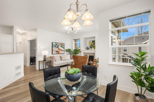 dining space featuring a chandelier and light hardwood / wood-style flooring