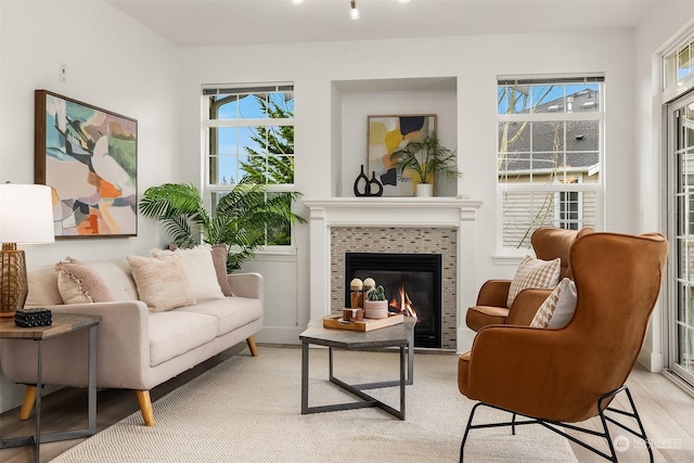 living area featuring a tiled fireplace