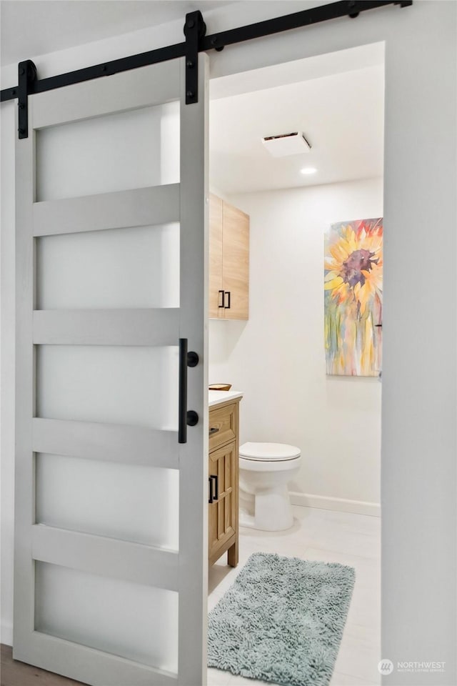 bathroom with toilet, vanity, and built in shelves