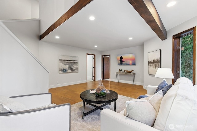 living room featuring light hardwood / wood-style flooring and beamed ceiling