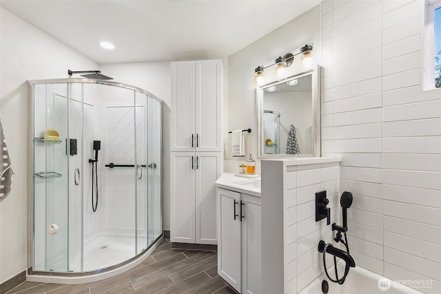 bathroom with vanity and a shower with shower door