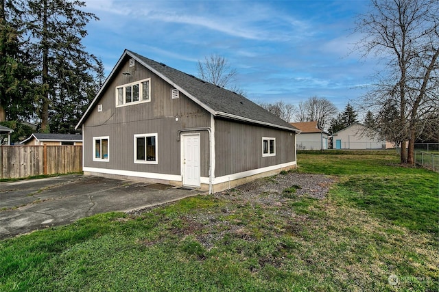 view of side of property with a lawn and a patio area