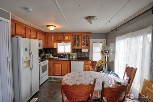 kitchen featuring decorative backsplash, sink, and white appliances