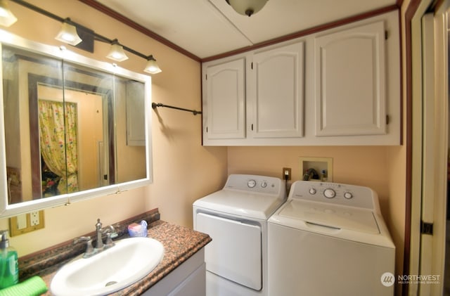 clothes washing area with sink, separate washer and dryer, and ornamental molding