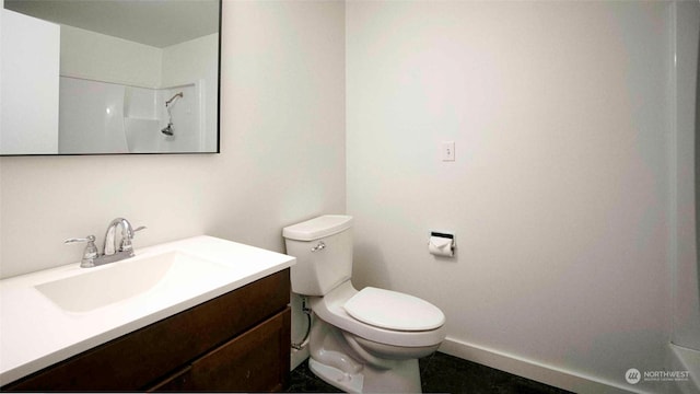 bathroom featuring toilet, vanity, and walk in shower