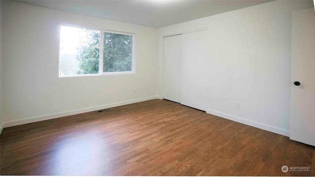 spare room featuring dark hardwood / wood-style floors