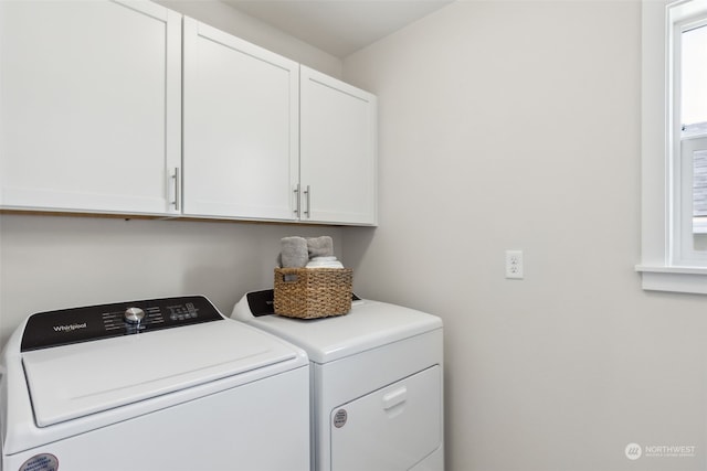 washroom featuring cabinets and washing machine and clothes dryer