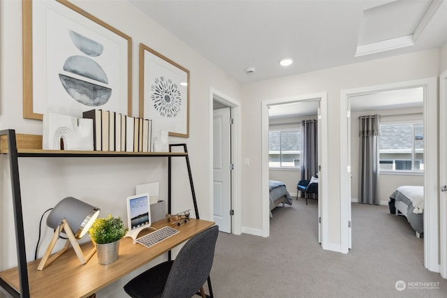 office area featuring light carpet