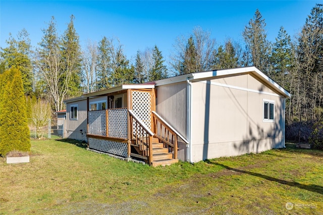 rear view of property featuring a lawn