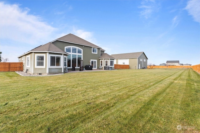 rear view of property featuring a lawn