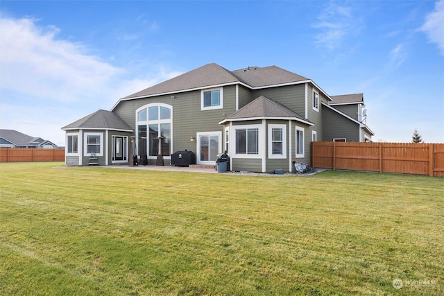 rear view of property with a yard and a patio