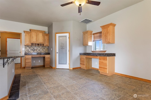 kitchen featuring light brown cabinets, backsplash, and ceiling fan