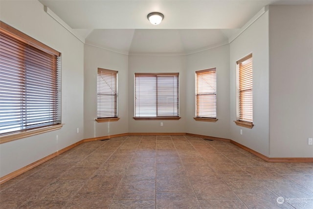 unfurnished room featuring lofted ceiling