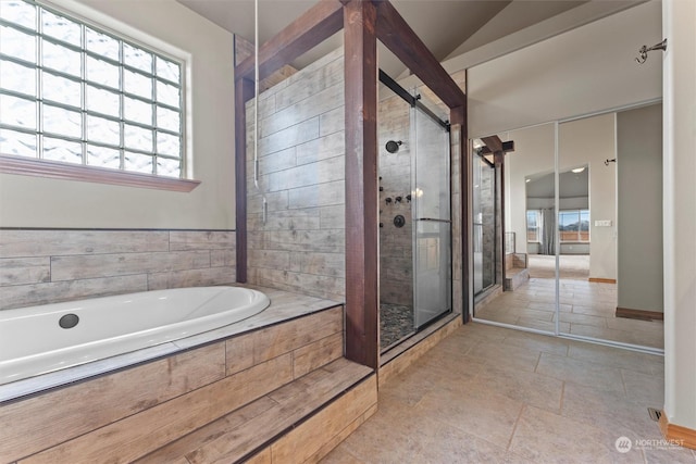 bathroom with independent shower and bath and lofted ceiling