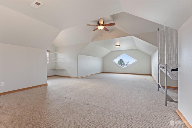 bonus room with ceiling fan, light carpet, and vaulted ceiling