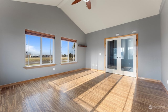 spare room with ceiling fan, wood-type flooring, french doors, and high vaulted ceiling