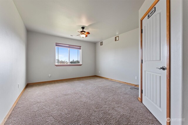 empty room with carpet and ceiling fan