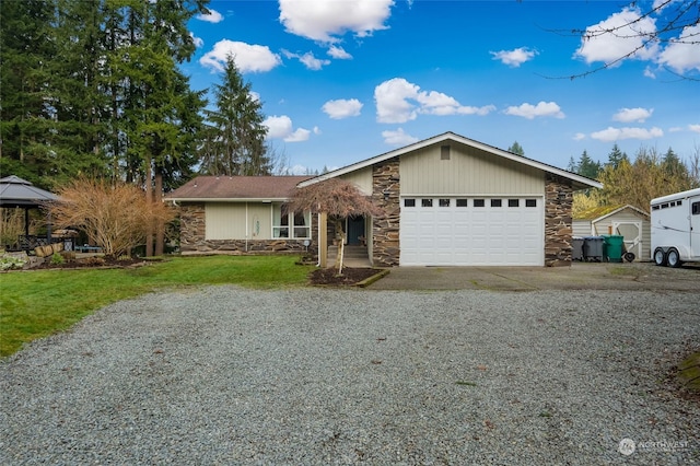 ranch-style home with a front yard and a garage