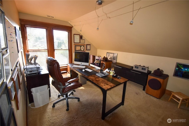 carpeted office with vaulted ceiling