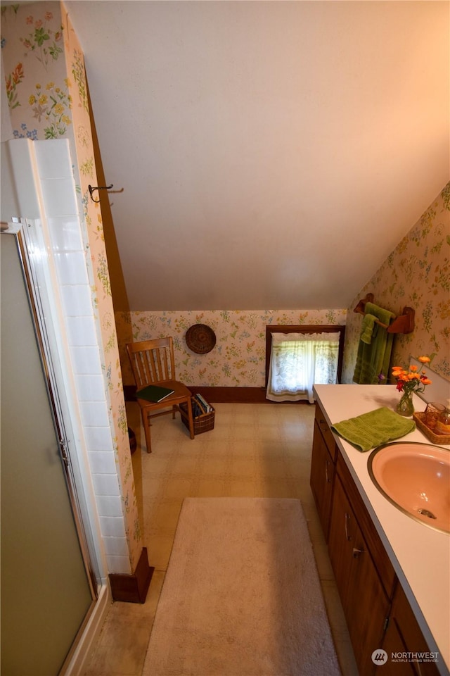 bathroom featuring walk in shower and vanity