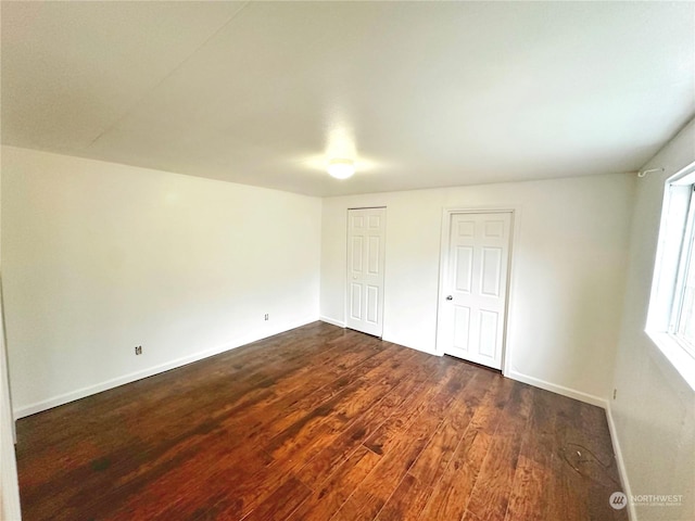 unfurnished bedroom featuring dark wood-type flooring